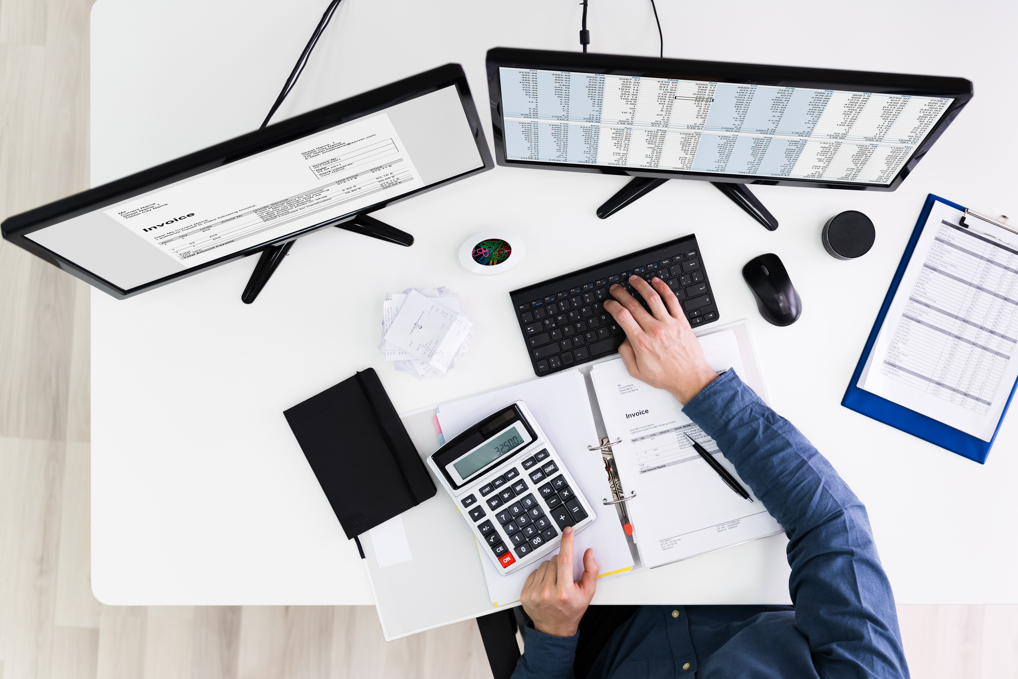 Young Businessman Calculating Bill In Office