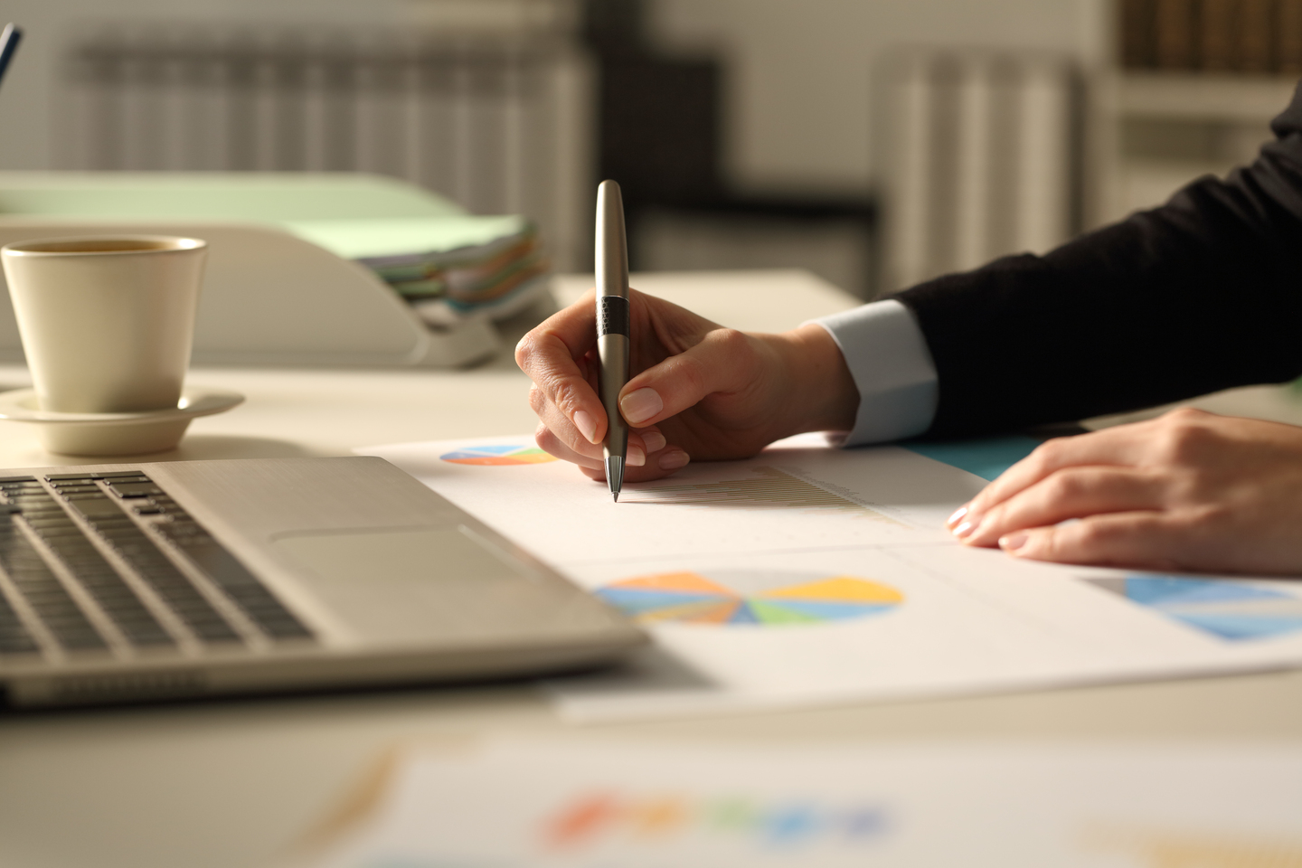 Business woman hands writing on report at night